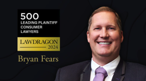 A man in a suit and tie is smiling next to a plaque reading "Lawdragon 500 Leading Plaintiff Consumer Lawyers, 2024, Bryan Fears," representing Fears Law.